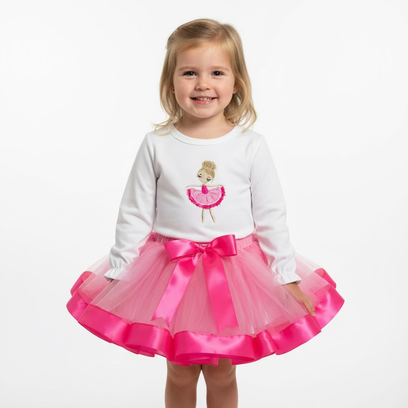 White top with pink tutu skirt and embroidered design on a girl